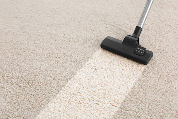 Vacuum cleaner on carpet - Фото, изображение