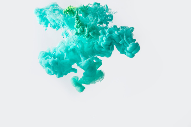 close up view of mixing of green and bright turquoise paints splashes in water isolated on gray - Photo, Image