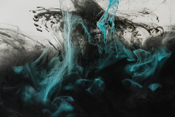 close up view of mixing of light gray, turquoise and black paints splashes in water isolated on gray - Photo, Image