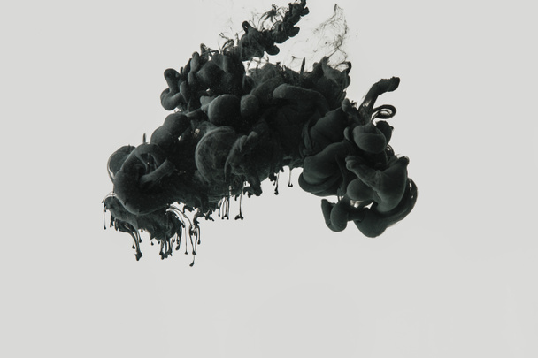 Close up view of black ink in water isolated on gray - Photo, Image