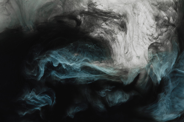 full frame image of mixing of light gray, turquoise and black paints splashes  in water isolated on gray - Photo, Image