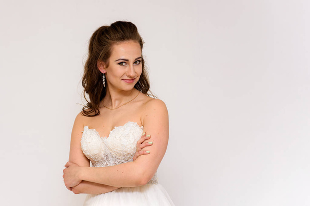 beautiful bride in white wedding dress in different poses on white backgrounds shows different emotions - Φωτογραφία, εικόνα