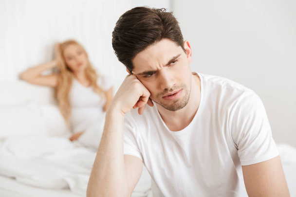 Young displeased loving couple in bed - Photo, Image