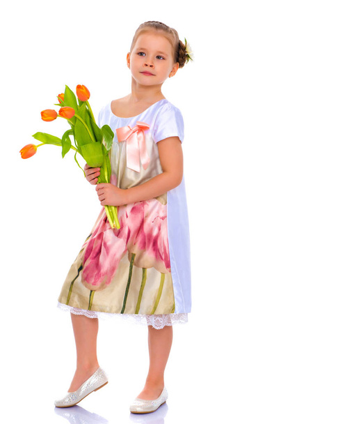Little girl with a bouquet of tulips. - Fotó, kép
