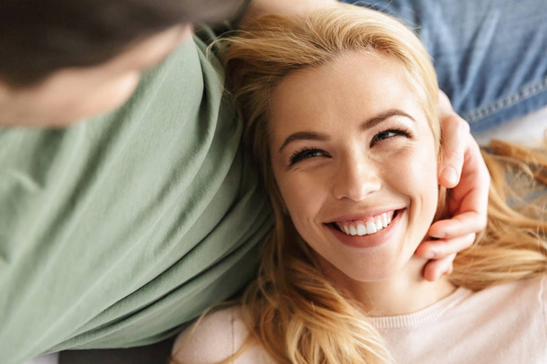Cute smiling young woman lies on her husband - Fotó, kép