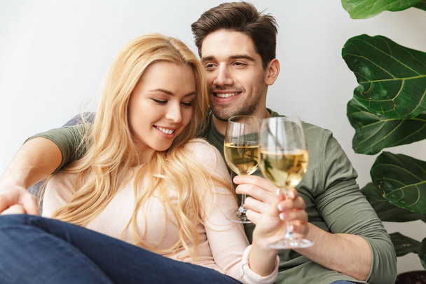 Happy young loving couple drinking alcohol white wine champagne. - Zdjęcie, obraz
