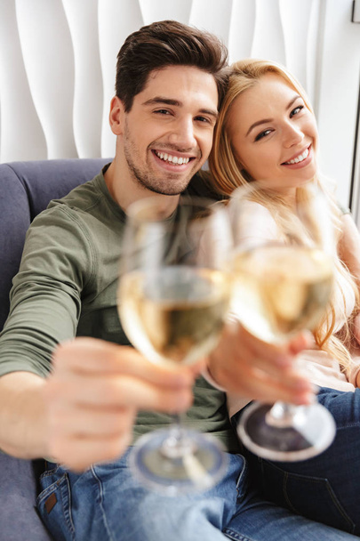 Happy young loving couple drinking alcohol white wine champagne. - 写真・画像