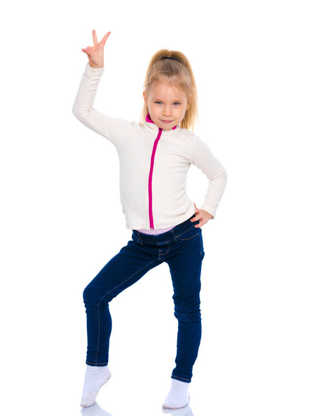Little gymnast girl shows thumb up. - Zdjęcie, obraz