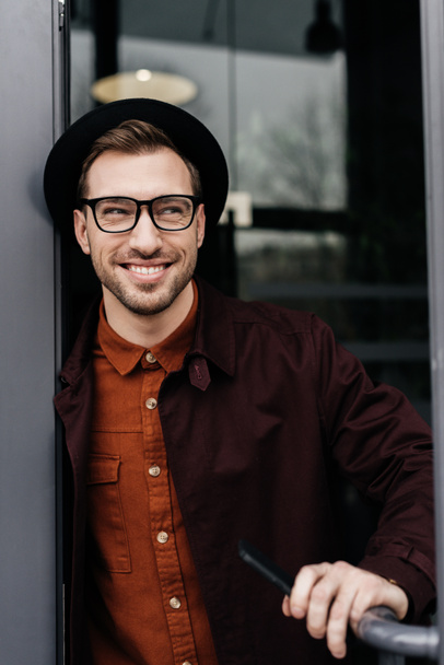 cheerful stylish man in eyeglasses and trendy hat - Fotó, kép