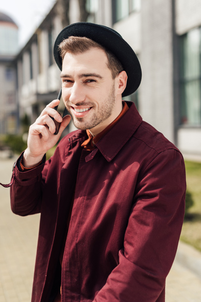 handsome smiling man in glasses talking on smartphone - Photo, image