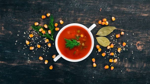 Tomato soup with chili and vegetables. Healthy food. On a black wooden background. Top view. Copy space for your text. - Fotoğraf, Görsel