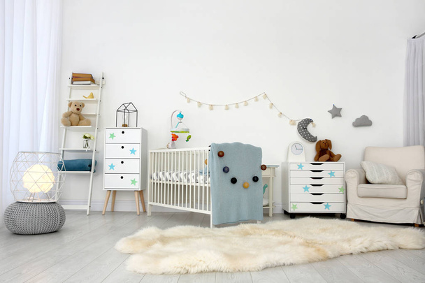 Cozy baby room interior with crib and armchair - Fotoğraf, Görsel