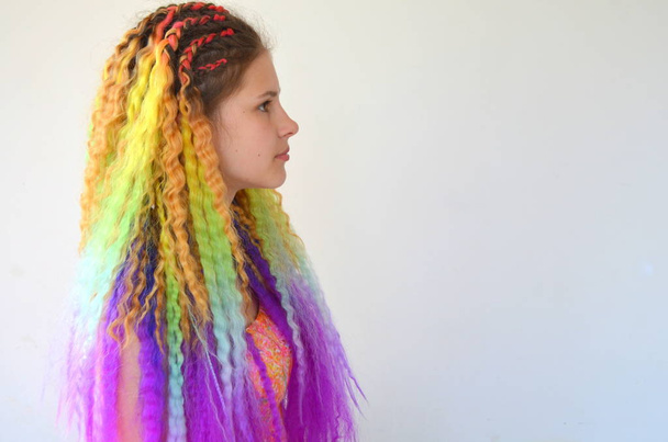 Uzun dalgalı saçlı bir kız gökkuşağı renklerde boyanmış. Tunik saç kanekalon - Fotoğraf, Görsel