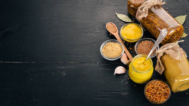 A set of mustard and spice. On a wooden background. Top view. Copy space for your text. - Foto, Bild