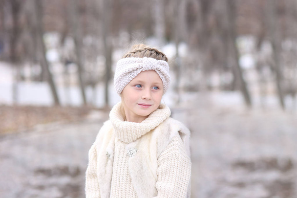 Portrait of a cute beautiful girl with blue eyes in fur vest - Zdjęcie, obraz