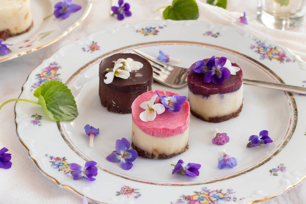 Raw vegan desserts with fresh violet flowers - Photo, Image