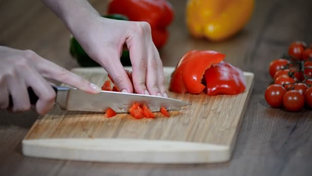 cutting fresh red pepper. Fresh pepper on a wooden board. Cook cut vegetables with a knife. - Footage, Video