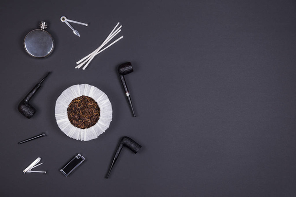 Smoking pipes and tobacco accessories on dark background. Top view. - Photo, Image