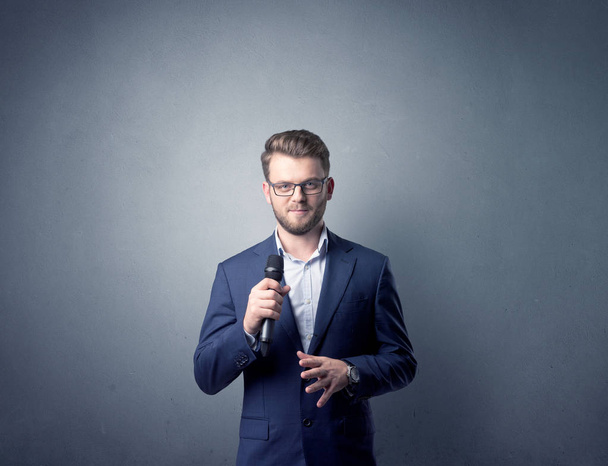 Businessman holding microphone - Photo, Image