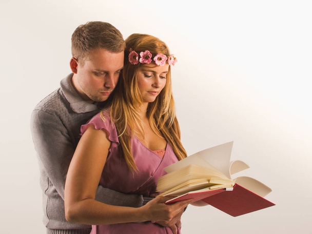 Young couple  standing with book and hugging - Photo, image