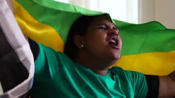 Jamaican Woman Celebrating with National Flag - Felvétel, videó