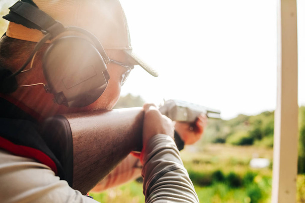 sniper sportsman shoots shotgun flying targets outside - Foto, Imagem