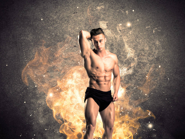 Healthy hot male showing muscles with fire - Foto, immagini