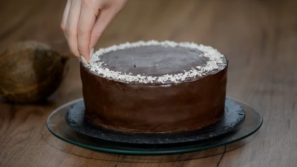 Decorating chocolate cake with coconut flakes - Footage, Video