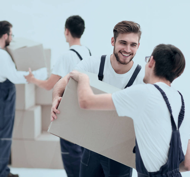 Portrait of movers holding box smiling isolated on white backgro - Valokuva, kuva
