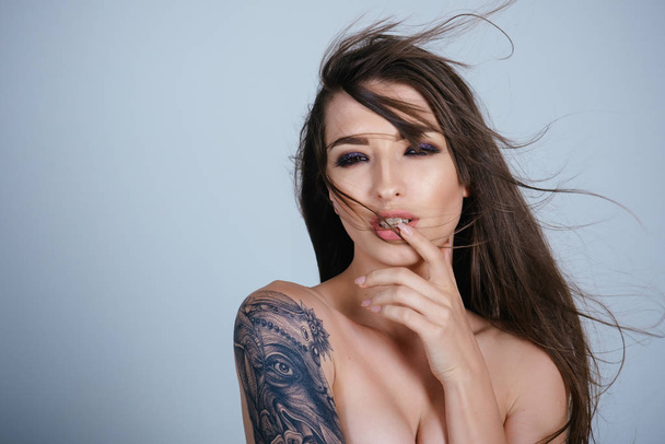 Portrait of lovely woman with tattoo on shoulder - Foto, imagen
