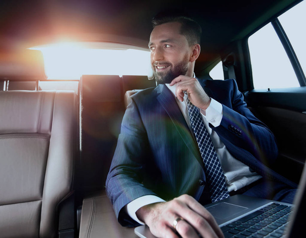 Confident businessman sitting in car - Foto, Imagen