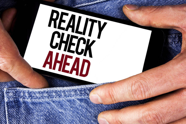 Word writing text Reality Check Ahead. Business concept for Unveil truth knowing actuality avoid being sceptical written on Mobile phone holding by man on the Jeans background. - Photo, Image