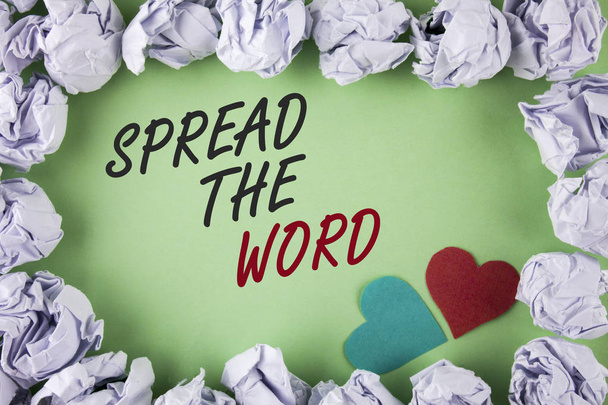 Text sign showing Spread The Word. Conceptual photo Run advertisements to increase store sales many fold written on plain green background within White Paper Balls Hearts next to it. - Photo, Image