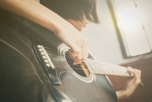 girl playing black guitar - Φωτογραφία, εικόνα