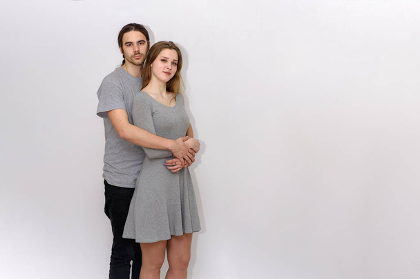 young and beautiful man and woman are standing on white background in different poses - 写真・画像