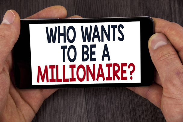 Writing note showing  who Wants To Be A Millionaire Question. Business photo showcasing Earn more money applying knowledge written on Mobile Phone Screen holding by man on the wooden background. - Photo, Image