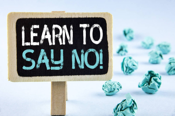 Writing note showing  Learn To Say No Motivational Call. Business photo showcasing Encouragement advice tips morality values written on Wooden Notice Board plain background Paper Balls next to it. - Photo, Image