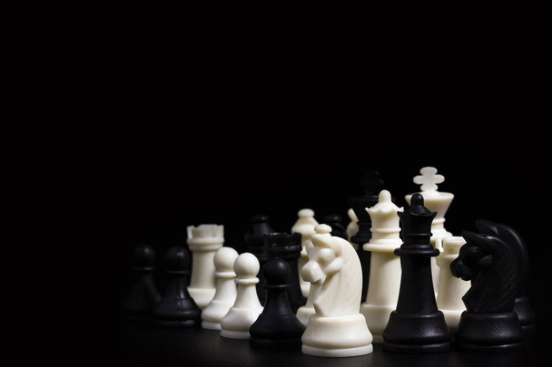 Chess in darkness on black background. Business planning concepts - Foto, Imagen