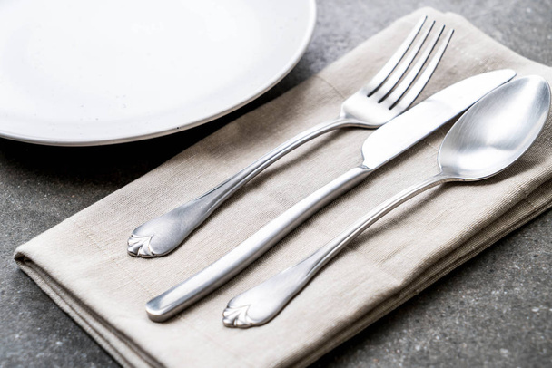 empty plate spoon fork and knife - Fotó, kép