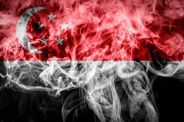National flag of Singapore from thick colored smoke on a black isolated background - Photo, Image