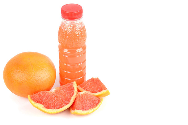 A fruit of grapefruit and a bottle with juice isolated on white  - Фото, изображение