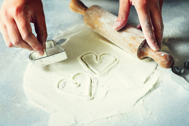 Heart of flour. Baking background with rolling pin, eggs, milk, butter on white kitchen table. Valentines day cooking, love concept. - Foto, Bild