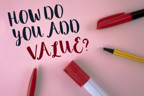 Text sign showing How Do You Add Value Question. Conceptual photo Bring business progress contribute earn written on plain Pink background Pens and Marker next to it. - Photo, Image
