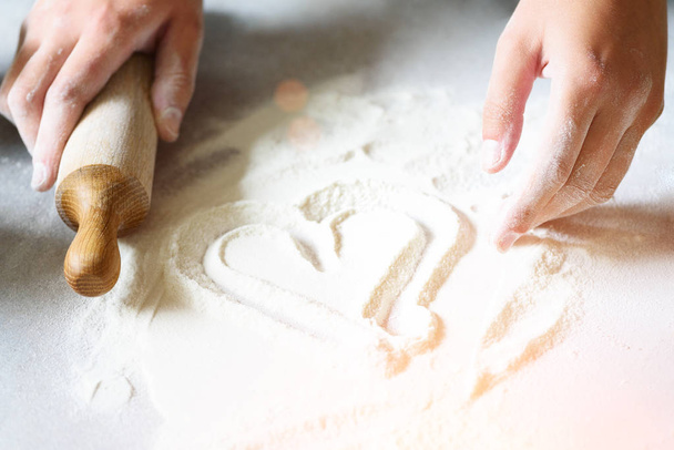Heart of flour. Baking background with rolling pin, eggs, milk, butter on white kitchen table. Valentines day cooking, love concept. - Fotografie, Obrázek