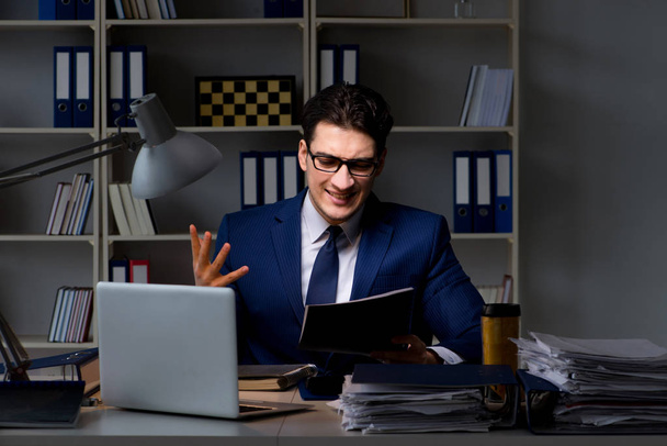 Employee working late to finish important deliverable task - Photo, image