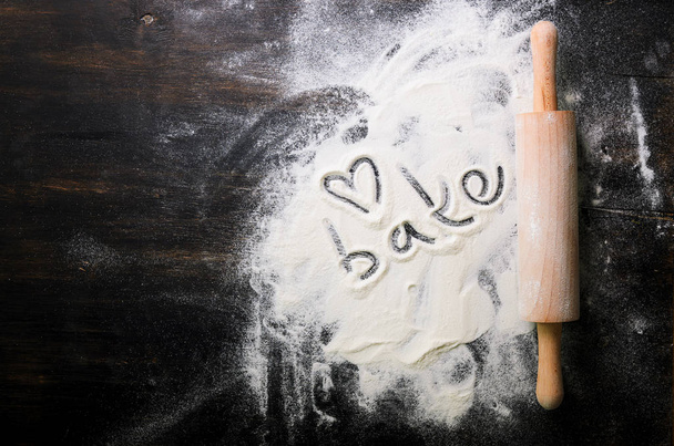 Baking background. Heart of flour, text Cook and rolling pin on dark table with copy space, top view - Fotó, kép