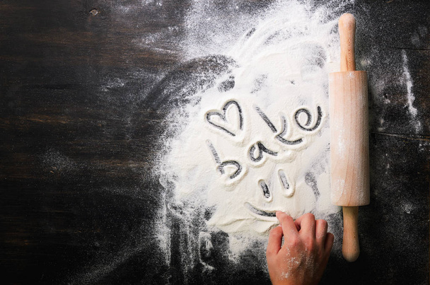 Baking background. Heart of flour, text Cook and rolling pin on dark table with copy space, top view - Fotografie, Obrázek
