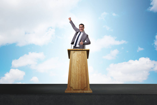 Man businessman making speech at rostrum in business concept - Photo, Image