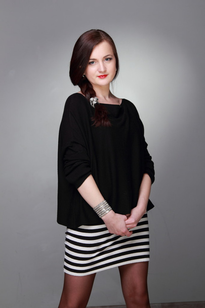Portrait of a beautiful girl in a striped skirt - Foto, Bild