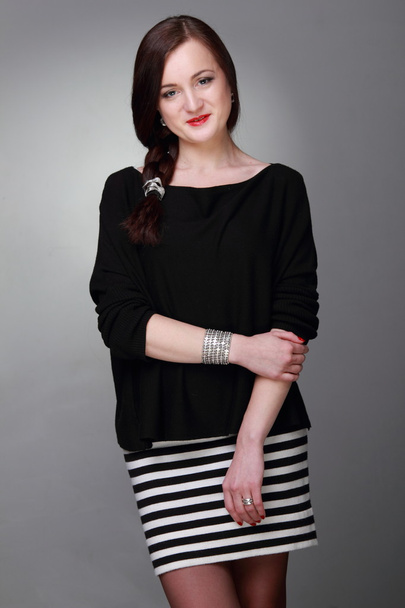 Portrait of a beautiful girl in a striped skirt - Zdjęcie, obraz